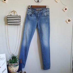 Guess, power curvy mid light wash jeans.